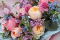 Floral backdrop, background. Flowers in bloom. Yellow pink blue bouquet with roses close-up