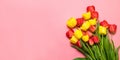 Floral background with tulips flowers on pink pastel background. Flat lay, top view Royalty Free Stock Photo