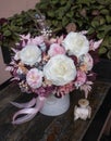 Floral bouquet in hat box. Beautiful delicate pink and white flowers in hat gift box grey color.