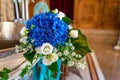 Floral bouquet made of blue hydrangea and white flowers, green leaves around. Focus on blue flowers Royalty Free Stock Photo