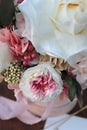 Floral bunch in round box. Bouquet in peach color of beautiful preserved flowers. White rose , mixed roses flowers, dried palm