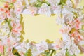 Floral composition with alstroemeria flowers and white frame on yellow background. Nature concept. Top view. Flat lay