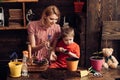 Floral concept. Little son help mother planting flowers in pot, floral decor. Mother and child work on floral