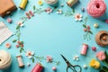Floral craft supplies arranged in a delightful springtime composition featuring yarn, thread spools, and delicate embroidered Royalty Free Stock Photo