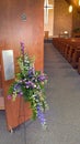 Floral cross arrangement by church door Royalty Free Stock Photo