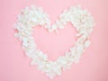 Floral crown wreath with white flowers on pink background in heart shape. Royalty Free Stock Photo
