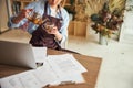 Floral designer having a tea break at the desk