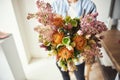 Floral designer holding a bunch of showy spring flowers Royalty Free Stock Photo