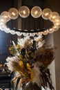 Floral door wreath made of colorful dry summer flowers and plants, close up. Fall wildflowers decoration. Natural