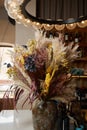 Floral door wreath made of colorful dry summer flowers and plants, close up. Fall wildflowers decoration. Natural