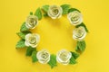 Floral frame background. Artificial flowers - light yellow rose with leaves on yellow chiffon. Free space for adding text. Close