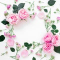 Floral frame composition with roses flowers, leaves and buds on white background. Flat lay, top view. Frame background Royalty Free Stock Photo