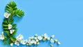 Floral frame of fresh greens and white flowers on blue background. Top view, copy space, flower flatlay. Place for text or beauty Royalty Free Stock Photo