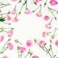Floral frame made of pink roses, buds and leaves on white background. Valentines day. Flat lay, Top view. Royalty Free Stock Photo