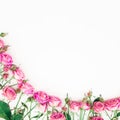 Floral frame made of pink roses buds on white background. Flat lay, Top view. Royalty Free Stock Photo