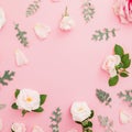 Floral frame made of pink and white roses flowers with leaves on pink background. Flat lay, top view Royalty Free Stock Photo