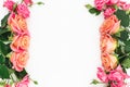 Floral frame made of roses, buds and green leaves on white background. Flat lay, top view. Spring background Royalty Free Stock Photo