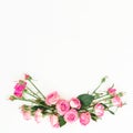 Floral frame made of roses flowers with copy space. Spring composition with pink roses on white background. Top view. Flat lay. Royalty Free Stock Photo