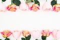 Floral frame made of roses and tulips flowers and green leaves on white background. Flat lay, top view. Flower background Royalty Free Stock Photo