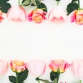 Floral frame made of roses and tulips flowers and green leaves on white background. Flat lay, top view. Flower background Royalty Free Stock Photo