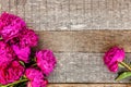 Floral frame with pink peonies on wooden background Royalty Free Stock Photo