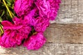 Floral frame with pink peonies on wooden background Royalty Free Stock Photo