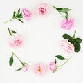 Floral frame of pink roses, peonies and green leaves on white background. Flat lay, top view. Flower background Royalty Free Stock Photo