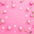 Floral frame with roses flowers and petals on pink background. Flat lay, Top view. Valentines day background Royalty Free Stock Photo