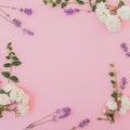 Floral frame with roses and lavender flowers on soft pink background. Flat lay, Top view Royalty Free Stock Photo