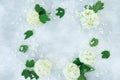 Floral frame of white flowers on gray background. Flat lay Royalty Free Stock Photo