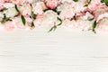 Floral frame wreath made of pink and beige peonies flower buds, eucalyptus branches and leaves isolated on white wooden Royalty Free Stock Photo