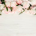 Floral frame wreath made of pink and beige peonies flower buds, eucalyptus branches and leaves isolated on white wooden Royalty Free Stock Photo