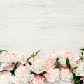 Floral frame wreath made of pink and beige peonies flower buds, eucalyptus branches and leaves isolated on white wooden Royalty Free Stock Photo