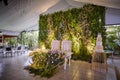 Floral green wall backstage main wedding table with cake