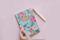 Floral journal/notepad on a pink background Royalty Free Stock Photo