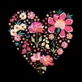 Floral ornament in the form of a heart. Beautiful embroidered flowers on black background