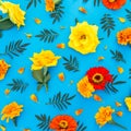 Floral pattern of bright yellow and red flowers with petals on blue background. Flat lay, top view Royalty Free Stock Photo