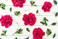 Floral pattern composition of red peony flowers and leaves on white rustic background. Flat lay Royalty Free Stock Photo