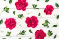 Floral pattern composition of red peony flowers and leaves on white rustic background Royalty Free Stock Photo