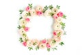 Floral pattern frame made of pink ranunculus and roses flower buds on white background. Flat lay, top view floral Royalty Free Stock Photo