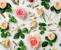 Floral pattern made of pink and beige roses, green leaves, branches on white background. Flat lay, top view. Valentine\'s Royalty Free Stock Photo