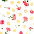 Floral pattern made of red roses flowers and orange rose petals on white background. Flat lay, top view. Royalty Free Stock Photo