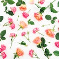 Floral pattern made of roses flowers, petals and leaves on white background. Flat lay, top view. Royalty Free Stock Photo