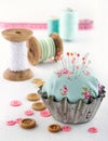 Floral pincushion in an old metal cupcake Royalty Free Stock Photo