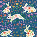 Cute white Bunny rabbits with beautiful whimsical spring flowers seamless pattern in orange, pink, yellow on blue background.