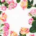 Floral round frame made of roses, buds and green leaves on white background. Flat lay, top view. Spring background Royalty Free Stock Photo