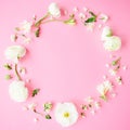 Floral round frame made of white flowers, buds and petals on pink background. Flat lay, top view. Pastel background. Royalty Free Stock Photo