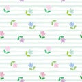 Floral seamless pattern. Embroidery tulips on the stripped background.