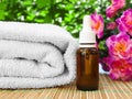 Floral spa and wellness design with oil bottle, towel