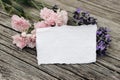 Floral stationery still life scene. Blank greeting card mock-up on old wooden table background with lavender and little Royalty Free Stock Photo